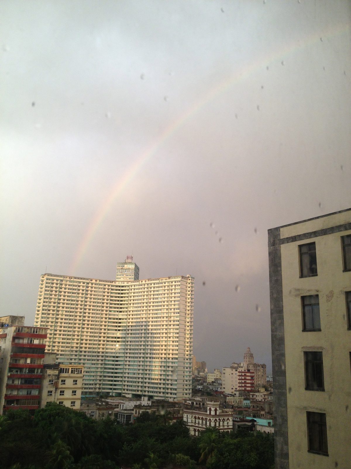 A morning rainbow over a Havana apartment building as seen from our hotel room.  Architecture...